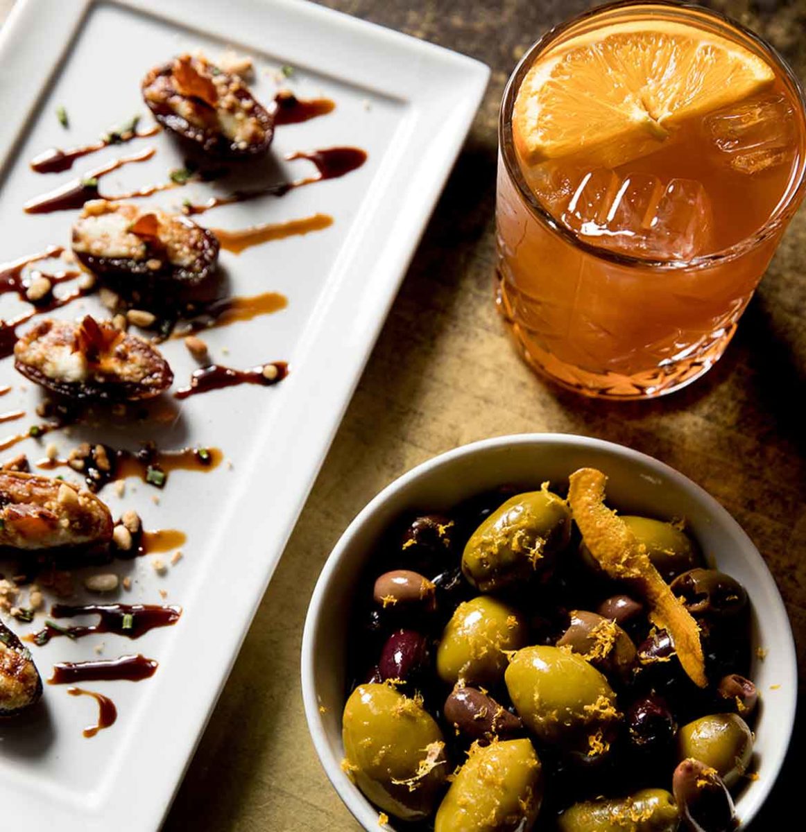 marinated olives and gorgonzola stuffed dates alongside a cocktail at the brass bar in our loft.