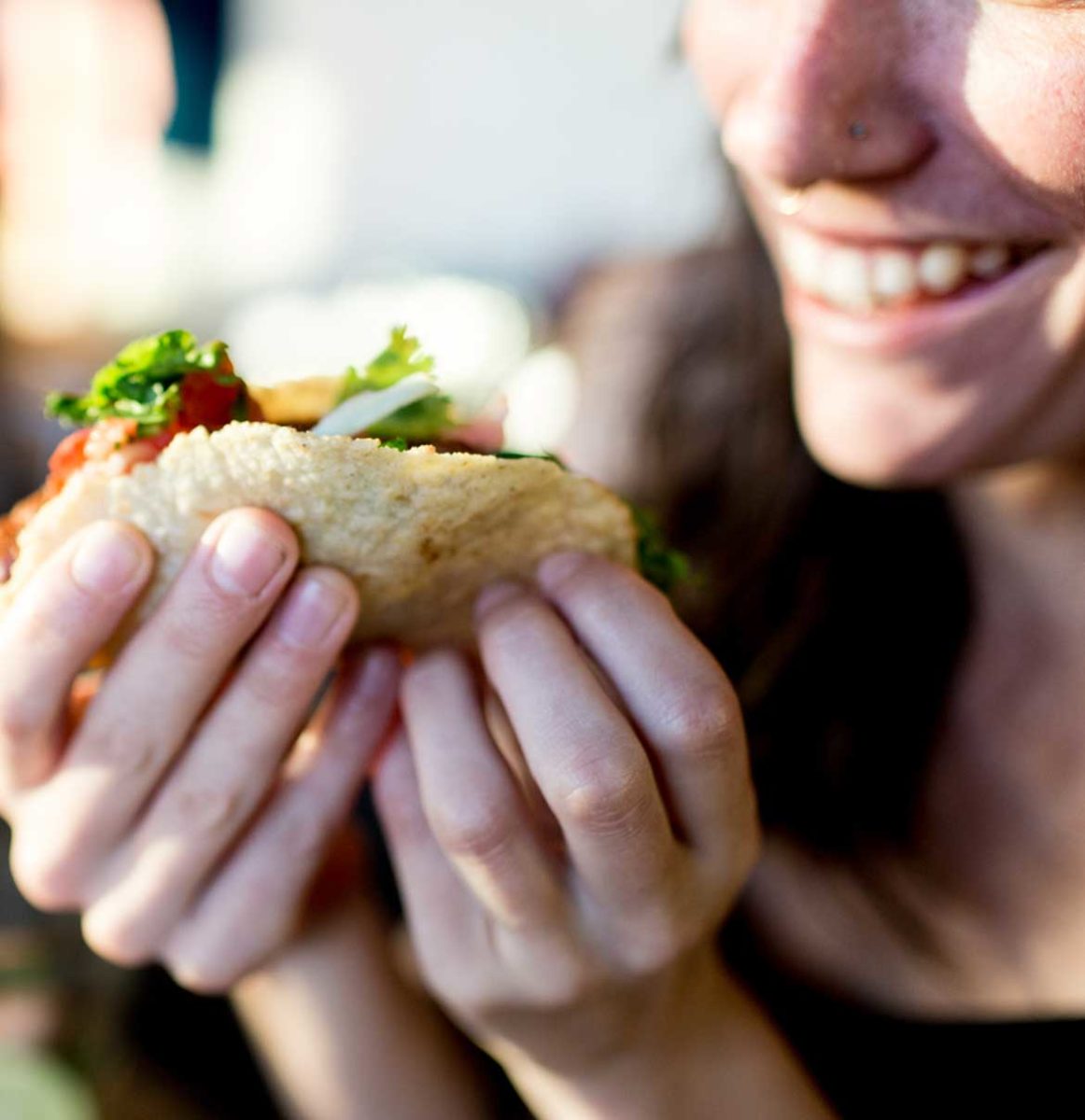 woman eating tacos